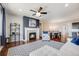 Well-lit living space featuring a cozy fireplace, modern furniture, and open access to the dining area at 12677 Fisher Dr, Englewood, CO 80112