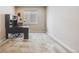 Bright office space featuring neutral carpet, black desk, and a large window offering natural light at 12677 Fisher Dr, Englewood, CO 80112