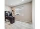 Cozy office space featuring neutral carpet, black desk, and a window providing ample natural light at 12677 Fisher Dr, Englewood, CO 80112