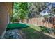 Fenced backyard with mature trees, grass lawn, and rock garden at 8893 W Harvard Dr, Lakewood, CO 80227