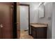 Bathroom featuring a granite countertop, decorative light fixture and a door to the hallway at 8893 W Harvard Dr, Lakewood, CO 80227