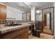 Bathroom featuring a large mirror, shower with glass door, and vanity with ample counter space at 8893 W Harvard Dr, Lakewood, CO 80227