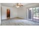 Spacious bedroom with neutral carpet, bright white walls and a door to the bathroom at 8893 W Harvard Dr, Lakewood, CO 80227