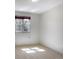 Bright bedroom featuring neutral carpet, white walls and a window offering natural light at 8893 W Harvard Dr, Lakewood, CO 80227