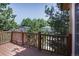 Outdoor deck offering views of the lush green trees surrounding the property at 8893 W Harvard Dr, Lakewood, CO 80227