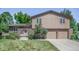 Charming front exterior with brick facade, arched entrance, and two-car garage at 8893 W Harvard Dr, Lakewood, CO 80227