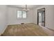 Open living room with neutral carpeting, a chandelier, and views to backyard at 8893 W Harvard Dr, Lakewood, CO 80227