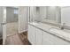 Bathroom with double vanity, granite countertops, and white cabinetry at 2125 Alyssa St, Fort Lupton, CO 80621