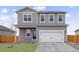 Charming two-story home featuring a covered porch, attached two-car garage, and well-maintained landscaping at 2125 Alyssa St, Fort Lupton, CO 80621