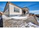 Back of home with patio and covered porch, rock landscaping at 6066 Leilani Dr, Castle Rock, CO 80108