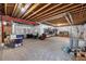Unfinished basement storage with exposed ceiling, concrete floor, and plastic covered walls at 6066 Leilani Dr, Castle Rock, CO 80108
