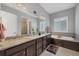 Beautiful bathroom features a large soaking tub and and sinks at 6066 Leilani Dr, Castle Rock, CO 80108