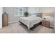 Bedroom with a large window, patterned bedding, and neutral tones at 6066 Leilani Dr, Castle Rock, CO 80108