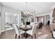Open concept space featuring a dining area with a view of the living room, kitchen and outdoor living space at 6066 Leilani Dr, Castle Rock, CO 80108