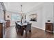Formal dining room features tray ceilings, modern chandelier, and wood floors at 6066 Leilani Dr, Castle Rock, CO 80108