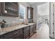 Kitchen features granite counters, stainless steel sink, and dark wood cabinets at 6066 Leilani Dr, Castle Rock, CO 80108