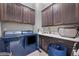 Functional laundry room with front load washer/dryer, storage and utility sink at 6066 Leilani Dr, Castle Rock, CO 80108