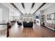 Spacious living room featuring wood beam ceiling, cozy fireplace, and seamless flow to dining and kitchen areas at 6066 Leilani Dr, Castle Rock, CO 80108