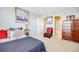 Bedroom featuring neutral walls, a comfortable bed, and a view into the bathroom at 26764 E Canyon Ave, Aurora, CO 80016