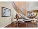 Grand foyer featuring hardwood floors, curved staircase, and stylish decor at 26764 E Canyon Ave, Aurora, CO 80016