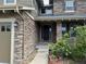 Welcoming front porch featuring stone detailing and beautiful landscaping at 26764 E Canyon Ave, Aurora, CO 80016
