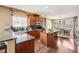 Gourmet kitchen with granite countertops, dark wood cabinetry, and stainless steel appliances at 26764 E Canyon Ave, Aurora, CO 80016