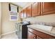 Functional laundry room with ample cabinet space, a utility sink, and modern washer and dryer at 26764 E Canyon Ave, Aurora, CO 80016