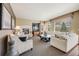 Spacious living room with a fireplace, large windows, and comfortable seating at 26764 E Canyon Ave, Aurora, CO 80016