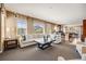 Open living space featuring a large sofa, natural light, and seamless flow to the kitchen at 26764 E Canyon Ave, Aurora, CO 80016