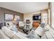 Bright living room with a fireplace, large TV, and comfortable sectional sofa at 26764 E Canyon Ave, Aurora, CO 80016