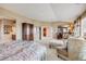 Bright main bedroom featuring sitting area, neutral carpet, and ensuite access at 26764 E Canyon Ave, Aurora, CO 80016