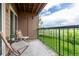 Cozy balcony with seating offers serene views of the surrounding green space and blue sky at 4899 S Dudley St # 14F, Littleton, CO 80123