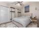 Comfortable bedroom with neutral decor, unique closet system, and decorative ceiling fan at 4899 S Dudley St # 14F, Littleton, CO 80123
