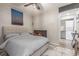 Inviting bedroom with a cozy bed, modern decor, and convenient access to the laundry area at 4899 S Dudley St # 14F, Littleton, CO 80123