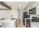 Modern kitchen featuring stainless steel appliances, white cabinets, and a large island at 4899 S Dudley St # 14F, Littleton, CO 80123