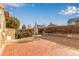 Backyard with a brick patio, a gravel area, retaining walls, and a privacy fence at 4094 S Lisbon Way, Aurora, CO 80013