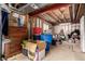 Unfinished basement with personal belongings stacked in boxes and totes, and a wooden dresser at 4094 S Lisbon Way, Aurora, CO 80013