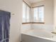 Bright bathroom with a soaking tub and two windows at 4094 S Lisbon Way, Aurora, CO 80013
