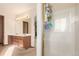 Well-lit bathroom featuring a double vanity, a glass enclosed shower and tile floors at 4094 S Lisbon Way, Aurora, CO 80013