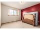 Minimalist bedroom with a red accent wall and window at 4094 S Lisbon Way, Aurora, CO 80013