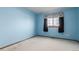 Light blue bedroom with carpet floors and a window at 4094 S Lisbon Way, Aurora, CO 80013