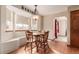 Bright dining area with built-in bench seating, hardwood floors, and a classic chandelier at 4094 S Lisbon Way, Aurora, CO 80013