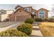 Charming two-story home featuring a two-car garage, landscaped yard, and covered entryway at 4094 S Lisbon Way, Aurora, CO 80013