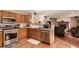 Efficient kitchen featuring wood cabinets, stainless steel appliances, and an open design at 4094 S Lisbon Way, Aurora, CO 80013