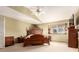 The bright main bedroom featuring a wooden bed frame and a window at 4094 S Lisbon Way, Aurora, CO 80013