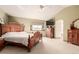 Spacious main bedroom with a large wooden bed, a ceiling fan, and a window with natural light at 4094 S Lisbon Way, Aurora, CO 80013