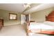 Bright main bedroom with neutral walls, wooden furniture, and an en-suite bathroom at 4094 S Lisbon Way, Aurora, CO 80013