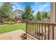 Landscaped backyard with green grass, a wooden fence, and a deck with a fire pit at 11411 W Cooper Dr, Littleton, CO 80127