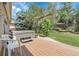 Well-maintained backyard deck featuring a hot tub, a pergola and lots of surrounding greenery at 11411 W Cooper Dr, Littleton, CO 80127