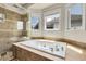 Inviting bathroom featuring separate shower and tub, creating a relaxing atmosphere at 11411 W Cooper Dr, Littleton, CO 80127